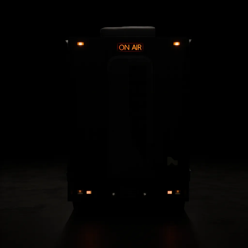 Dimly lit front view of a vehicle with an illuminated 'ON AIR' sign at the top center against a dark background.